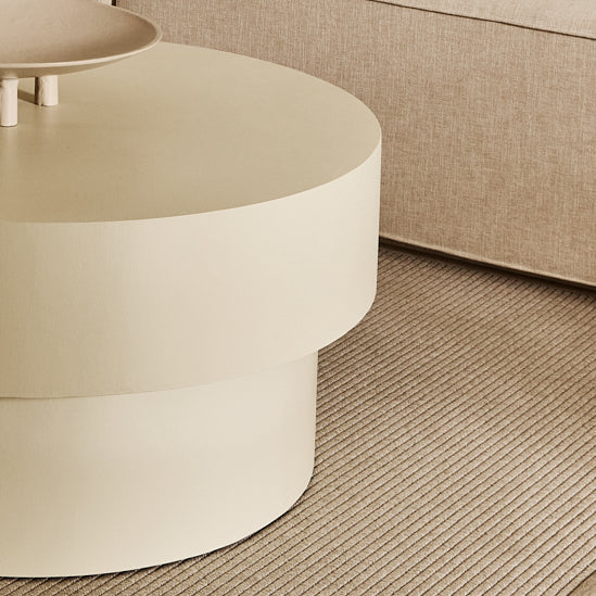 Round microcement cofee table from the Andre Collection, 90cm diameter, with smooth matte finish and minimalist silhouette set in a modern living space.