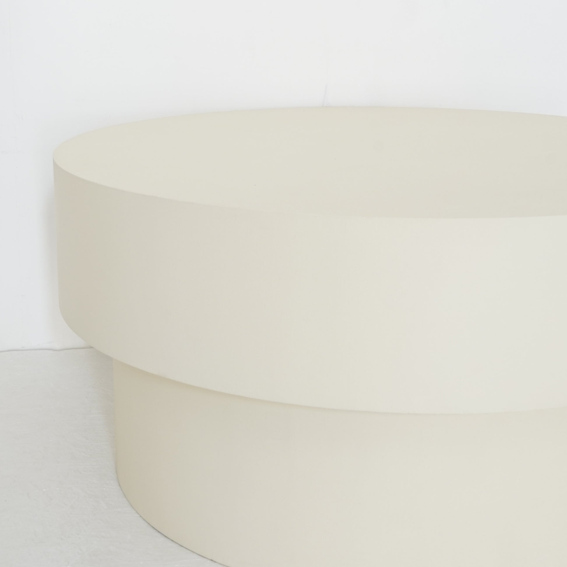 Round microcement cofee table from the Andre Collection, 90cm diameter, with smooth matte finish and minimalist silhouette set in a modern living space.