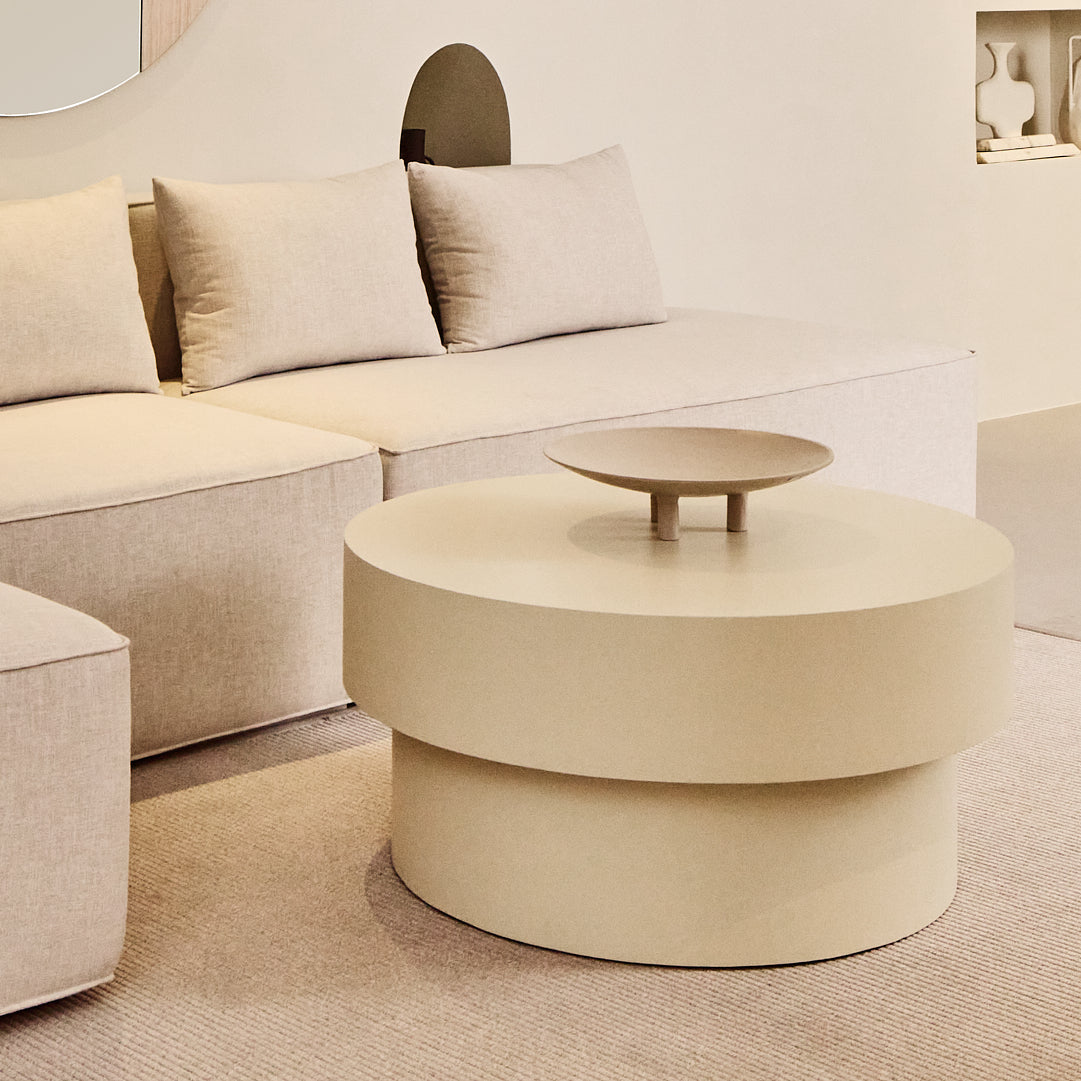 Round microcement cofee table from the Andre Collection, 90cm diameter, with smooth matte finish and minimalist silhouette set in a modern living space.