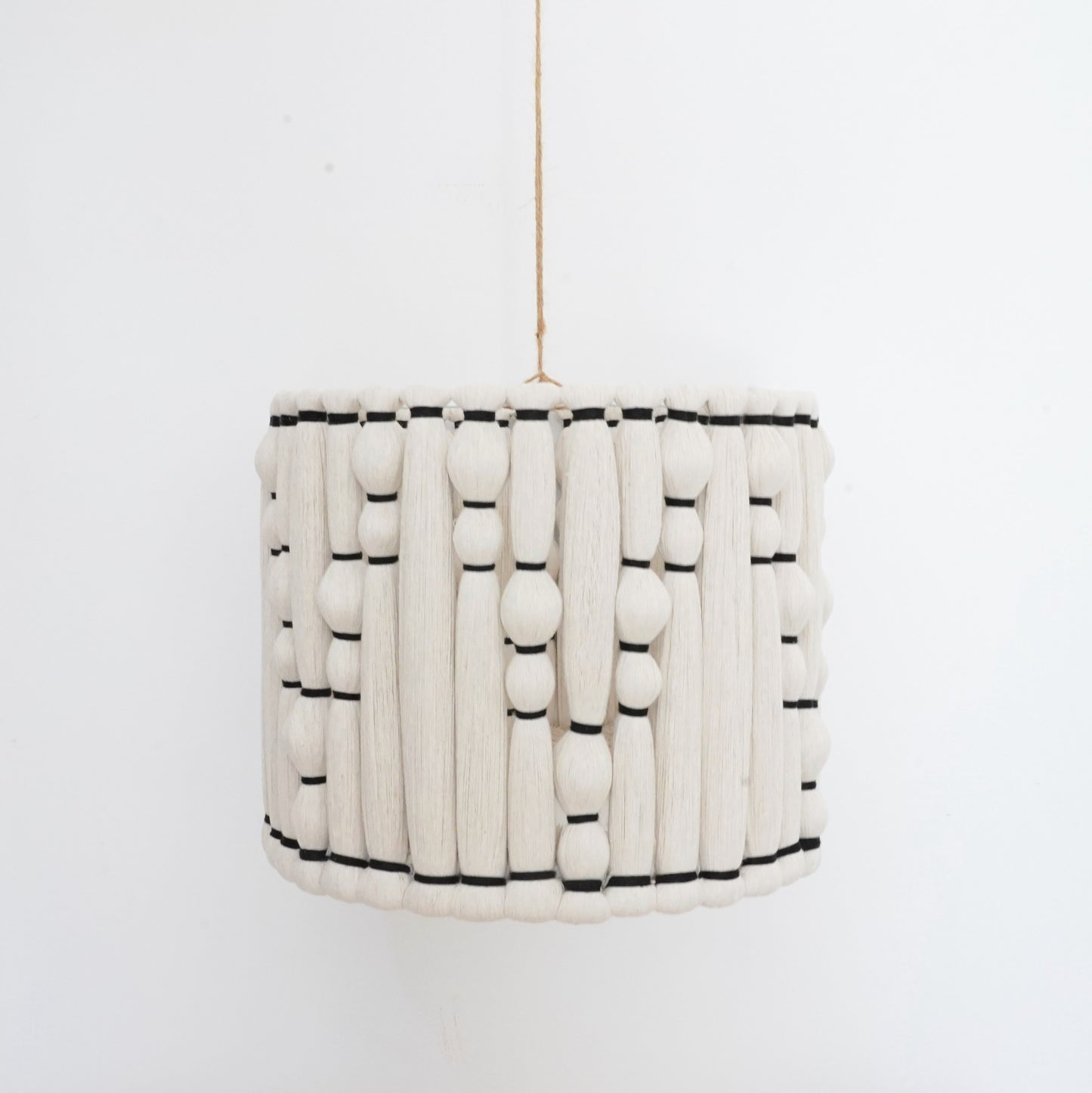 Ivory and black handcrafted cotton tassel and lampshade from the Hilo Collection.