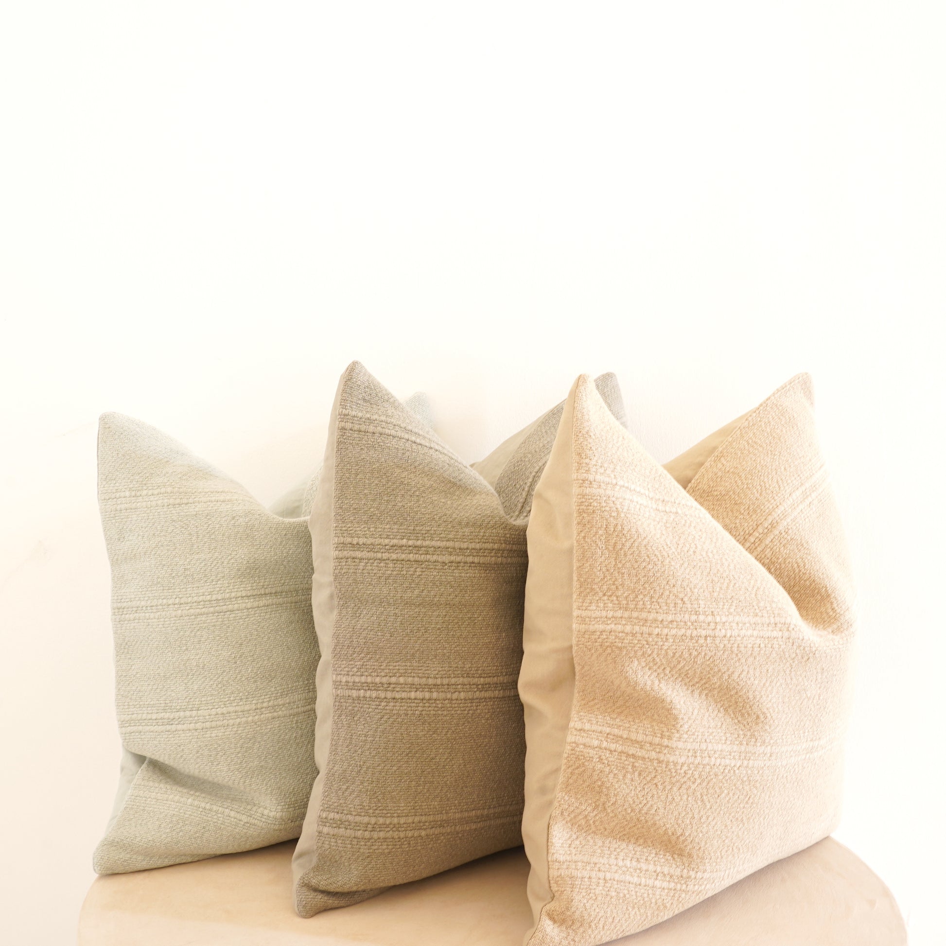 Cleo cotton-linen cushion in Ice, Shell, and Stone.