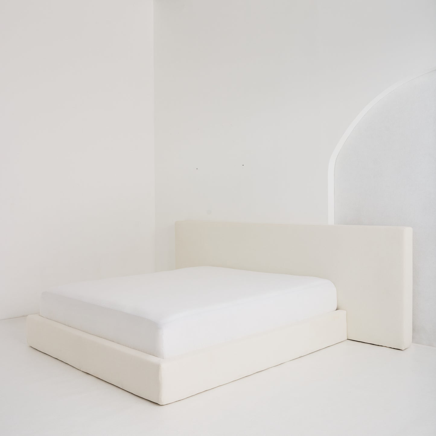 Custom-made Coastal Bed with oversized headboard, styled in serene neutral fabric for a relaxed, luxurious bedroom aesthetic.