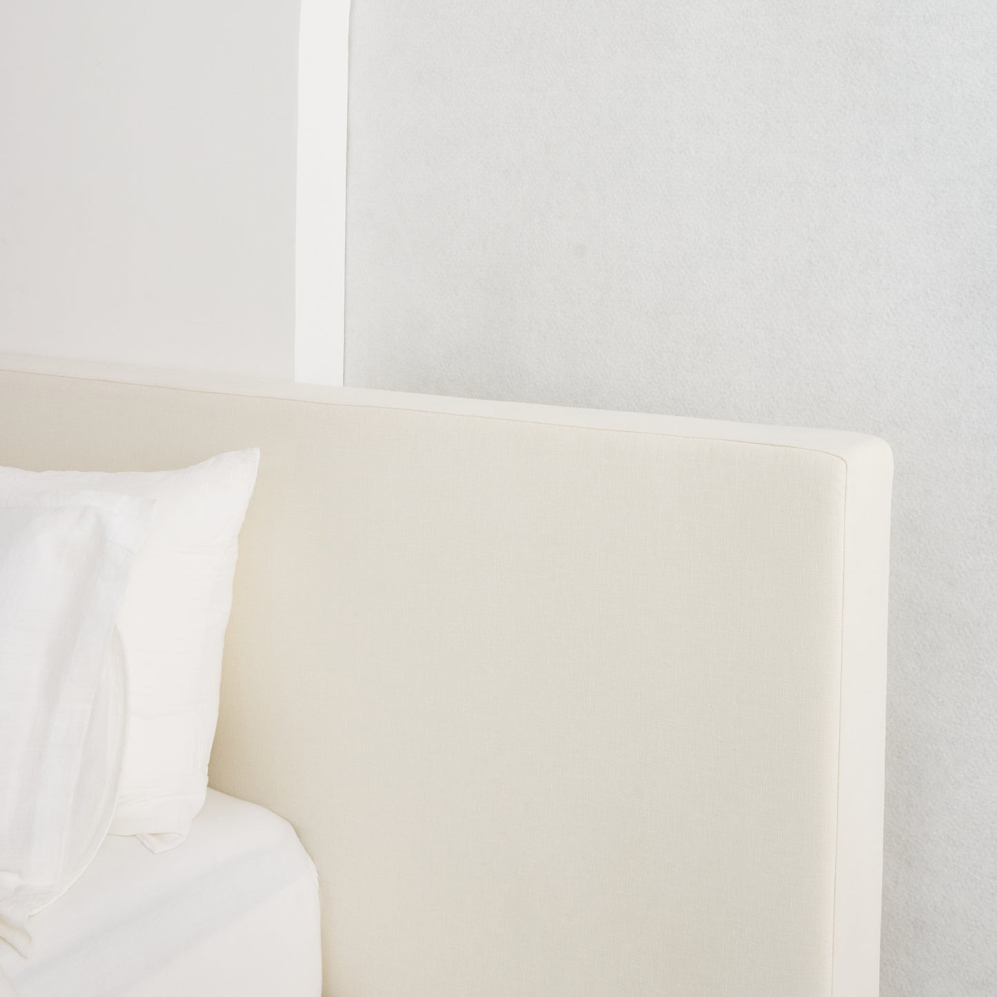 Custom-made Coastal Bed with oversized headboard, styled in serene neutral fabric for a relaxed, luxurious bedroom aesthetic.