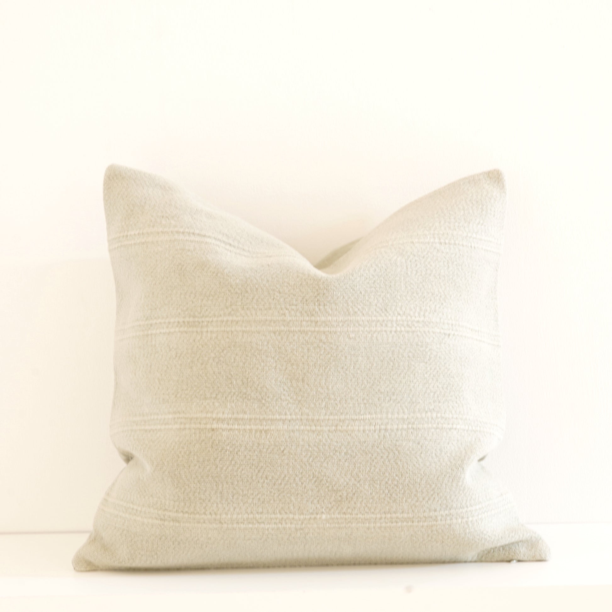 Cleo cotton-linen cushion in Ice, Shell, and Stone.