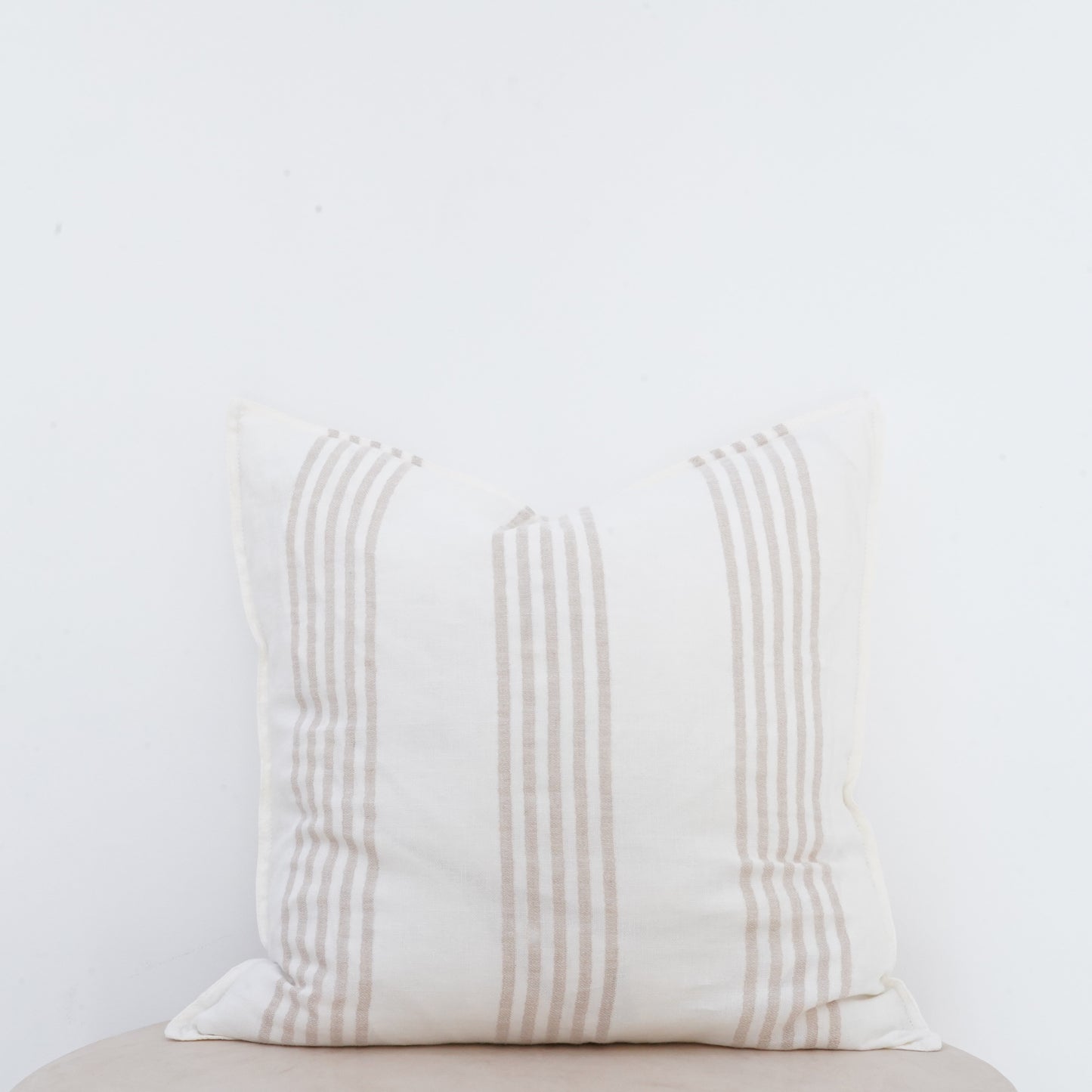 Natural linen cushion with French seam, classic and elegant décor accent.