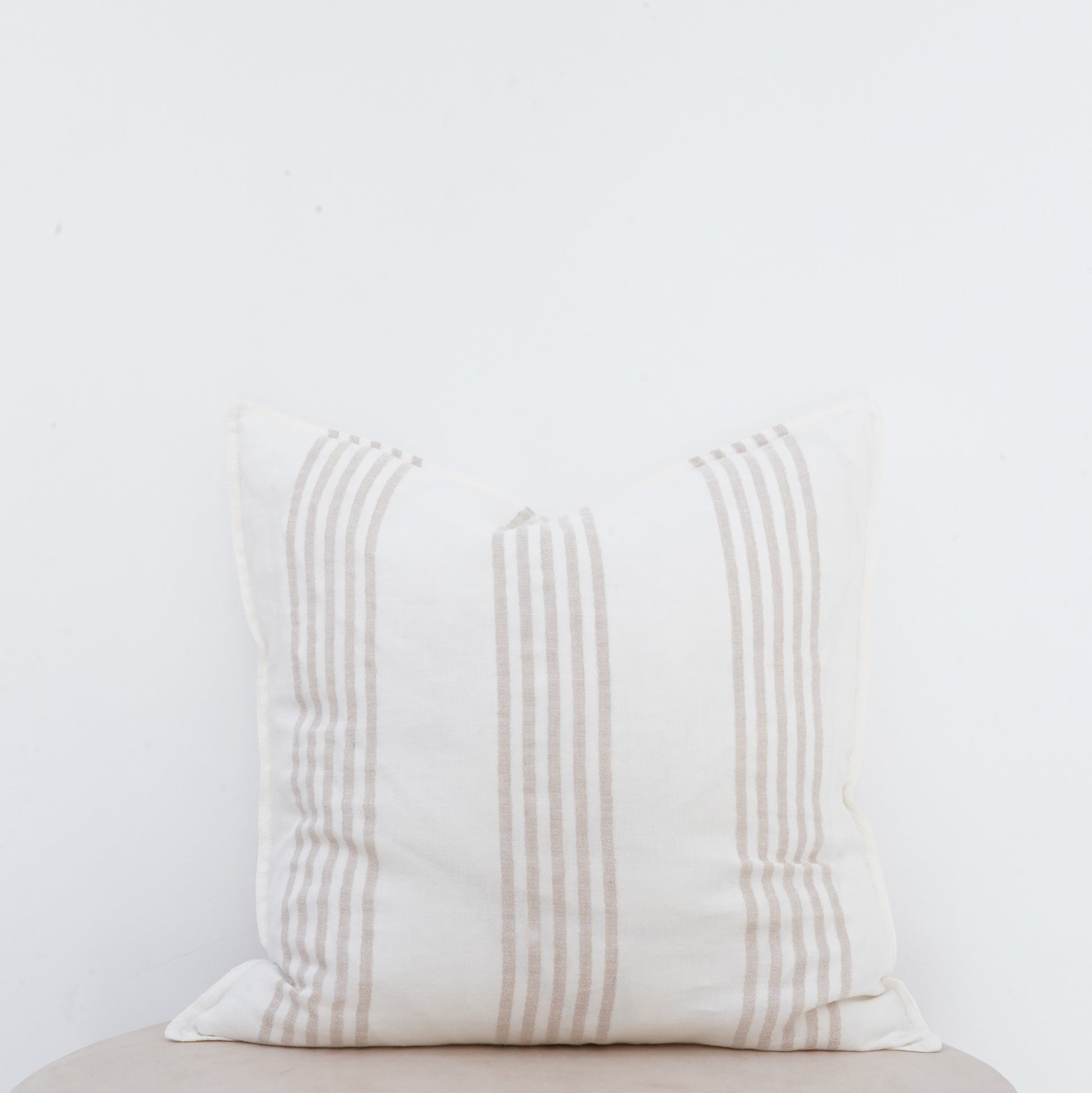 Natural linen cushion with French seam, classic and elegant décor accent.