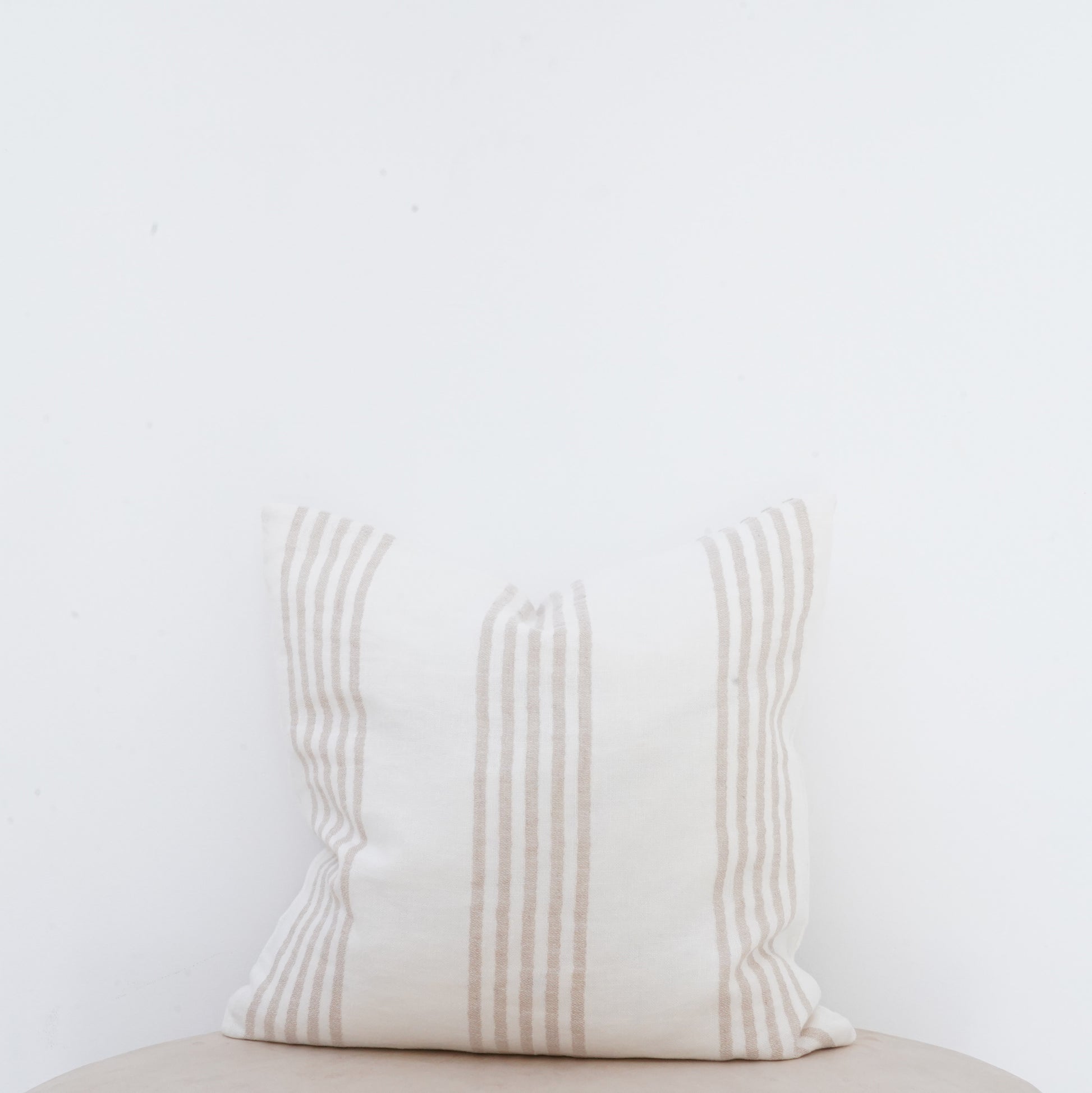 Natural linen cushion with French seam, classic and elegant décor accent.