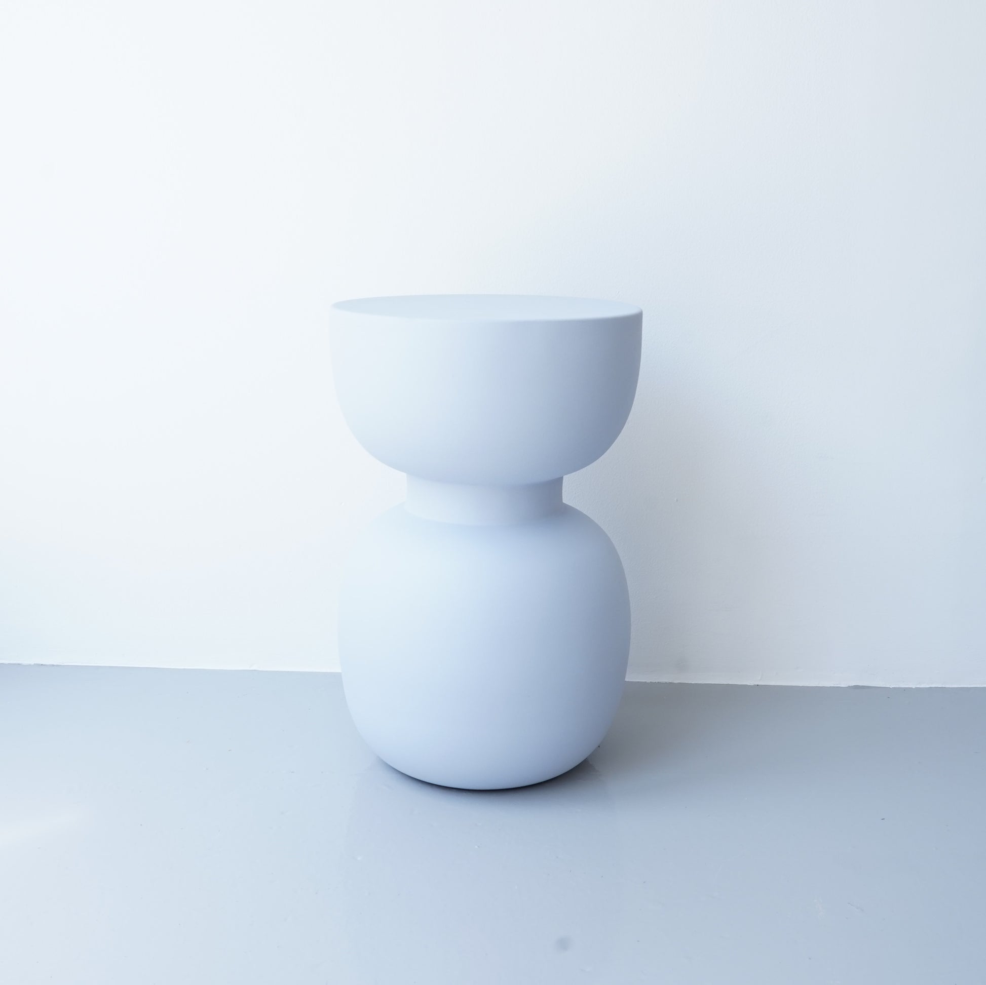 Note & Tone Side Tables in iron, Fog and Snow finishes, styled as a nested duo beside a modern sofa in Tribe Dubai showroom.