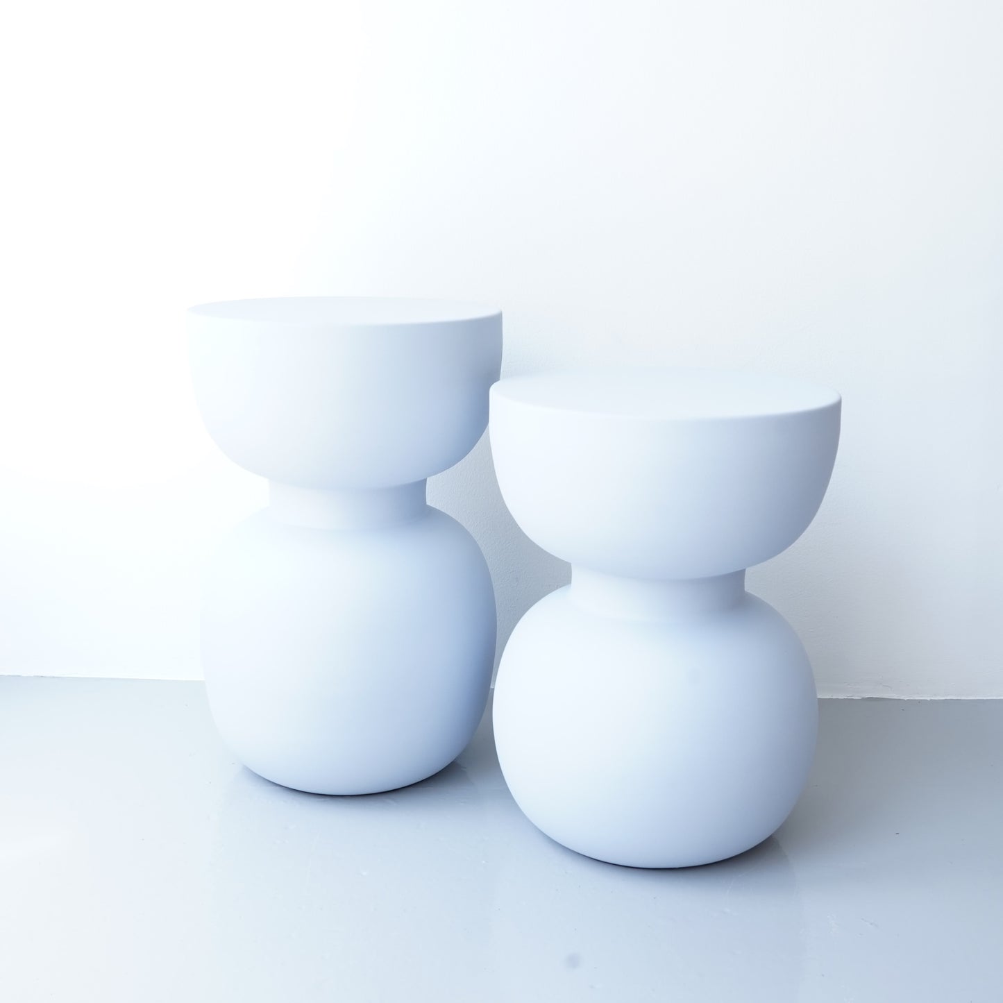 Note & Tone Side Tables in iron, Fog and Snow finishes, styled as a nested duo beside a modern sofa in Tribe Dubai showroom.