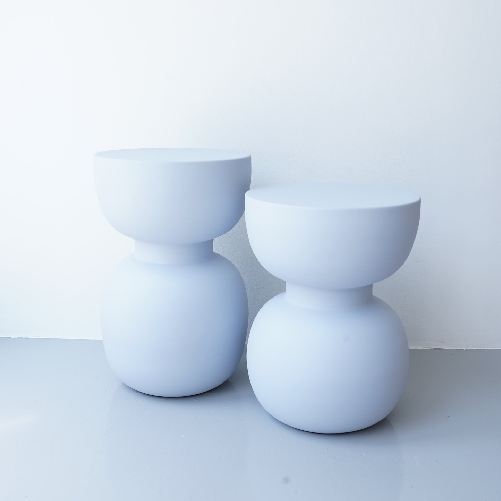 Note & Tone Side Tables in iron, Fog and Snow finishes, styled as a nested duo beside a modern sofa in Tribe Dubai showroom.