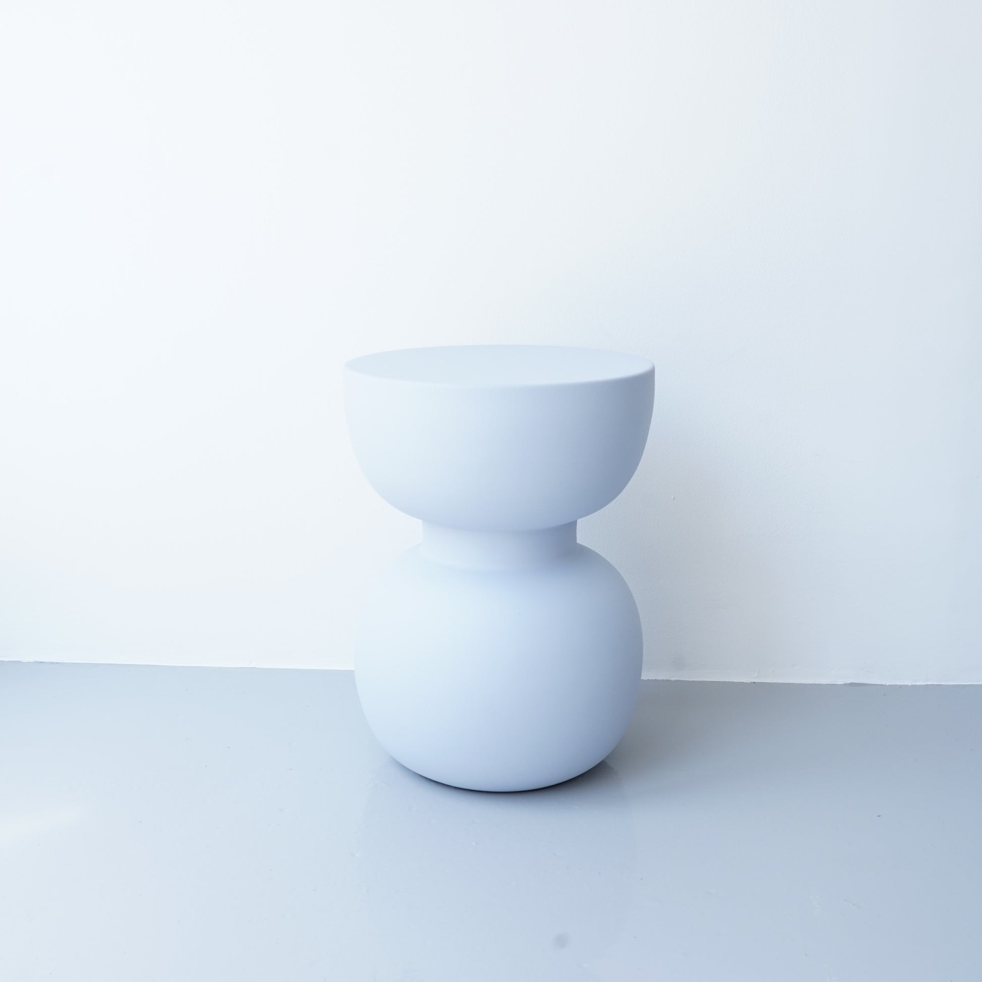 Note & Tone Side Tables in iron, Fog and Snow finishes, styled as a nested duo beside a modern sofa in Tribe Dubai showroom.