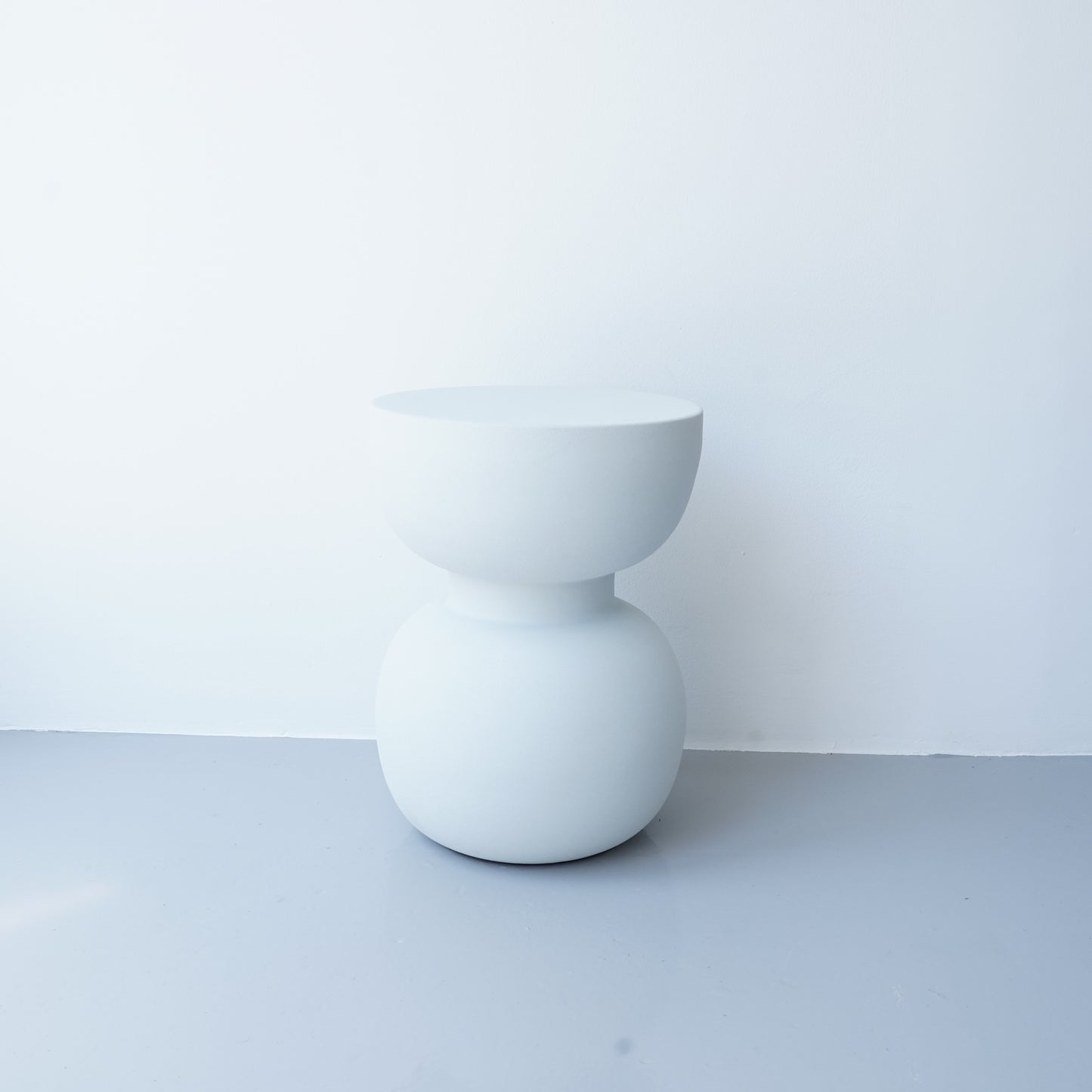 Note & Tone Side Tables in iron, Fog and Snow finishes, styled as a nested duo beside a modern sofa in Tribe Dubai showroom.