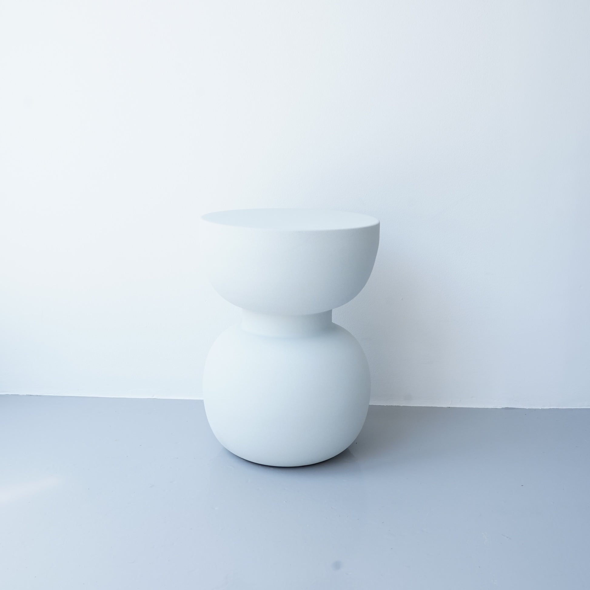 Note & Tone Side Tables in iron, Fog and Snow finishes, styled as a nested duo beside a modern sofa in Tribe Dubai showroom.