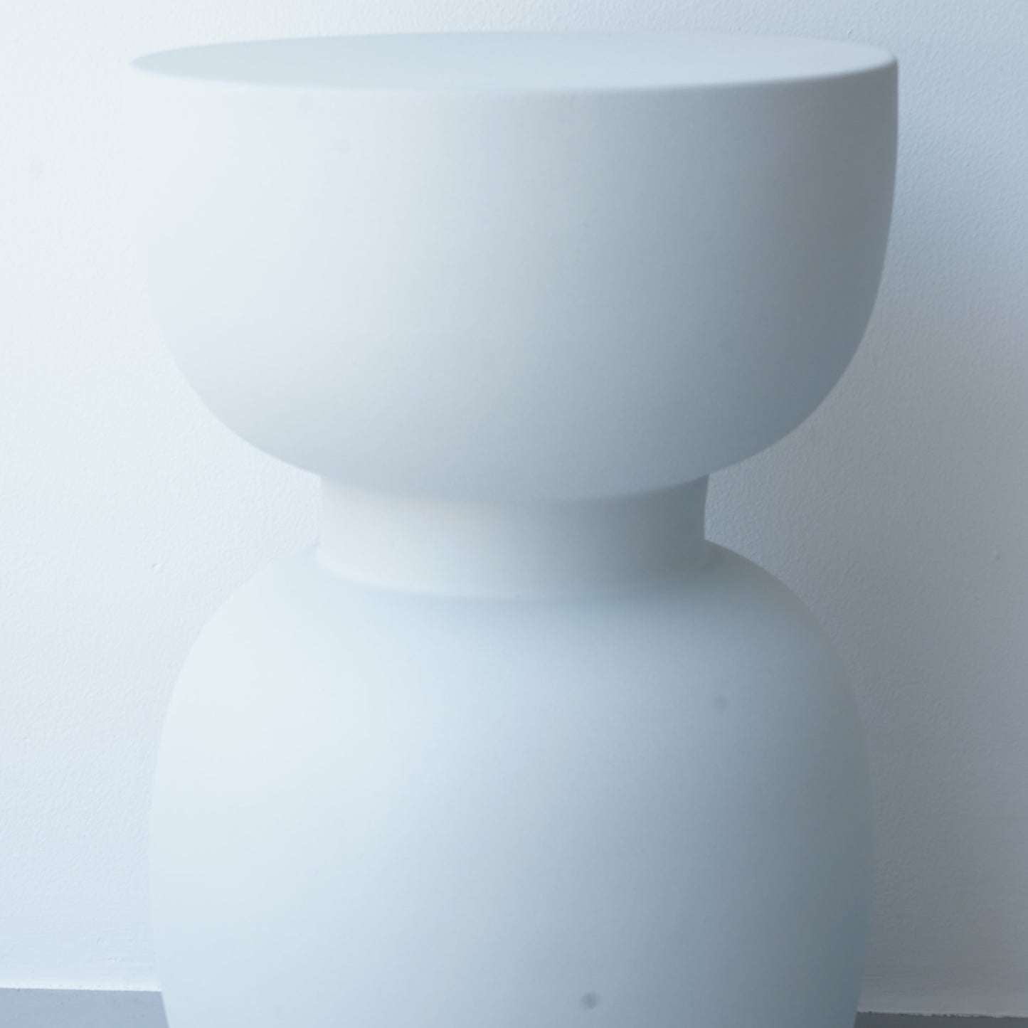 Note & Tone Side Tables in iron, Fog and Snow finishes, styled as a nested duo beside a modern sofa in Tribe Dubai showroom.