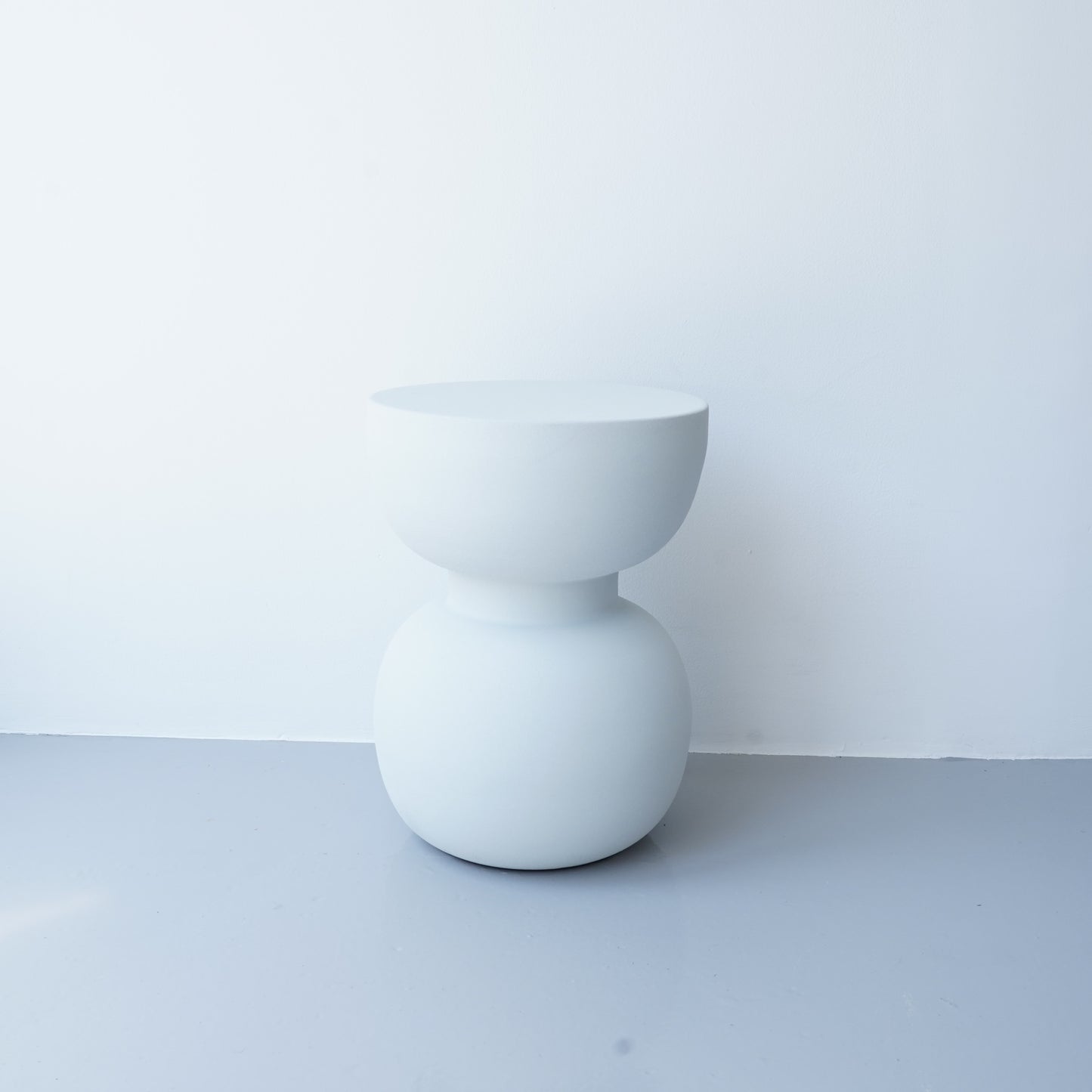 Note & Tone Side Tables in iron, Fog and Snow finishes, styled as a nested duo beside a modern sofa in Tribe Dubai showroom.