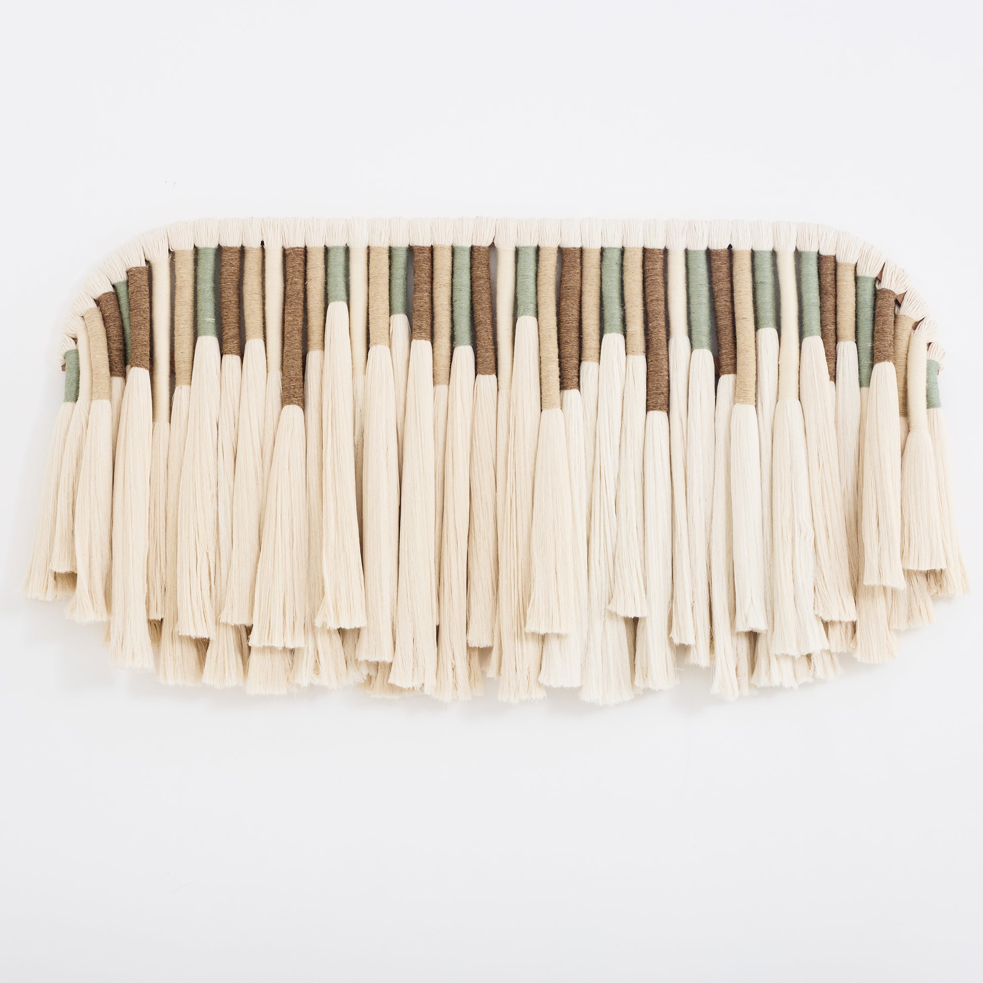 Handcrafted woven cotton tapestry in ivory, green, and beige tones,