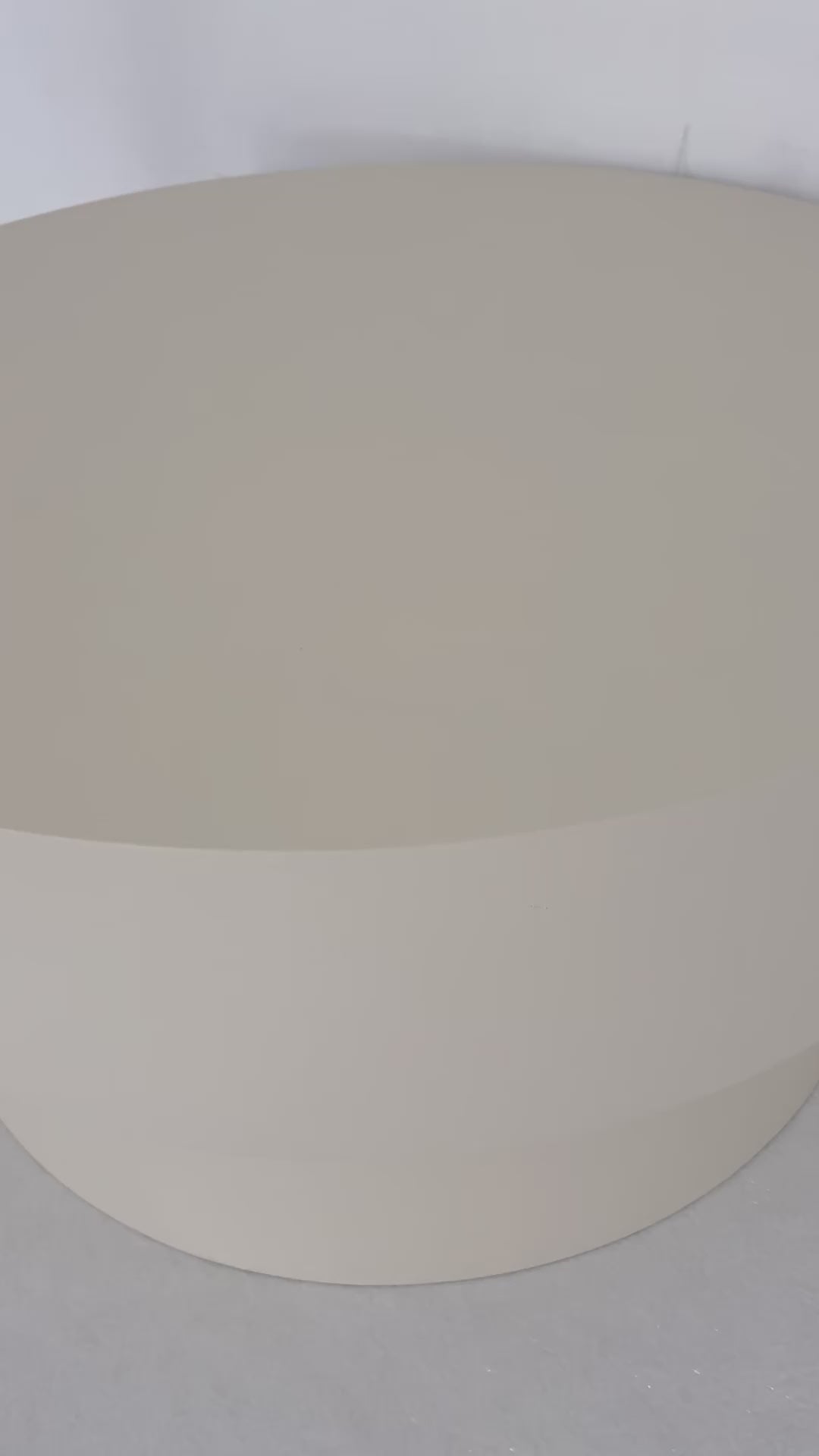 Round microcement cofee table from the Andre Collection, 90cm diameter, with smooth matte finish and minimalist silhouette set in a modern living space.