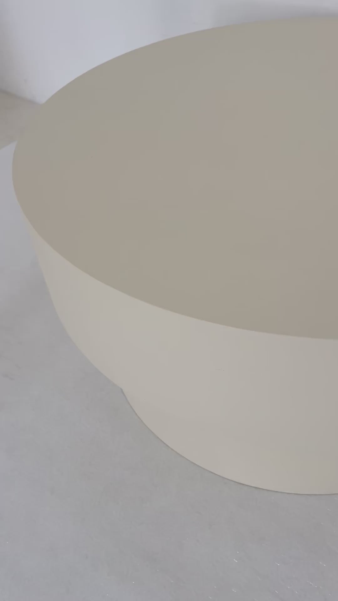Round microcement cofee table from the Andre Collection, 90cm diameter, with smooth matte finish and minimalist silhouette set in a modern living space.