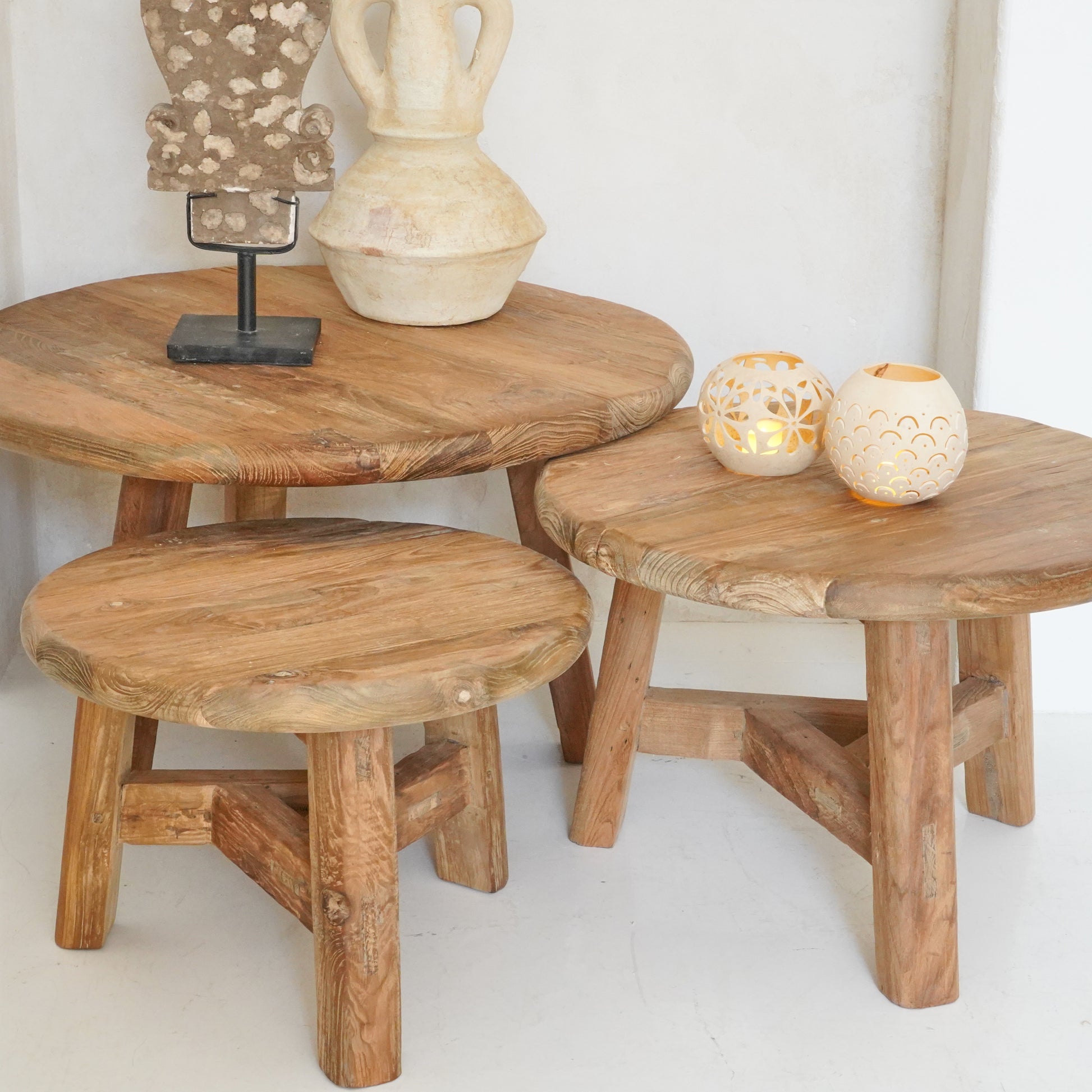 Reclaimed wood nesting tables in small, medium, and large sizes with a rustic, natural finish.