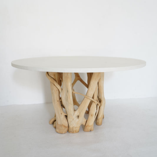 Coastal Dining Table with tree root base and round micro cement top, blending natural form with contemporary style for indoor use.