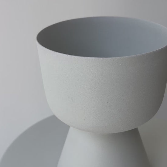 Decorative iron pots in black, chocolate, and snow finishes for modern interiors.
