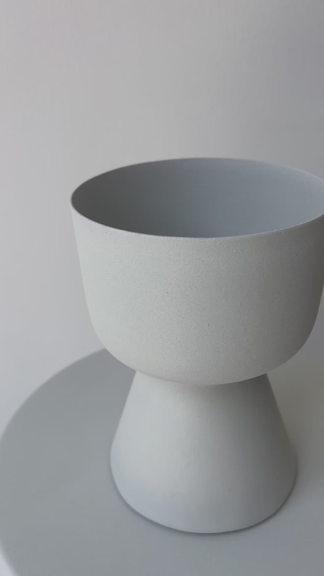 Decorative iron pots in black, chocolate, and snow finishes for modern interiors.
