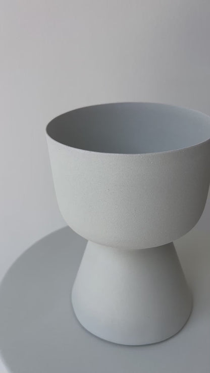 Decorative iron pots in black, chocolate, and snow finishes for modern interiors.