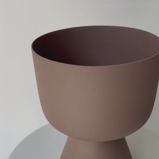 Decorative iron pots in black, chocolate, and snow finishes for modern interiors.