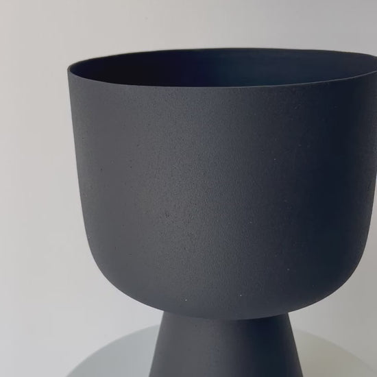 Decorative iron pots in black, chocolate, and snow finishes for modern interiors.